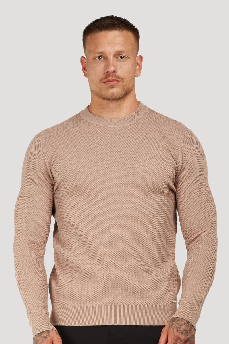Man wearing a beige textured crew neck sweater