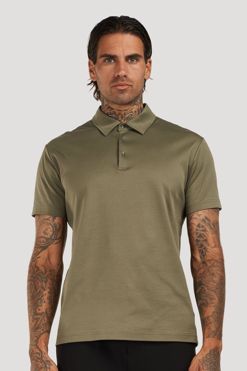 Man wearing an olive green polo shirt with a classic collar and short sleeves