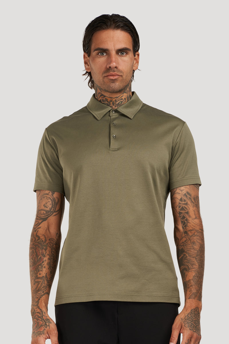 Man wearing an olive green polo shirt with a classic collar and short sleeves